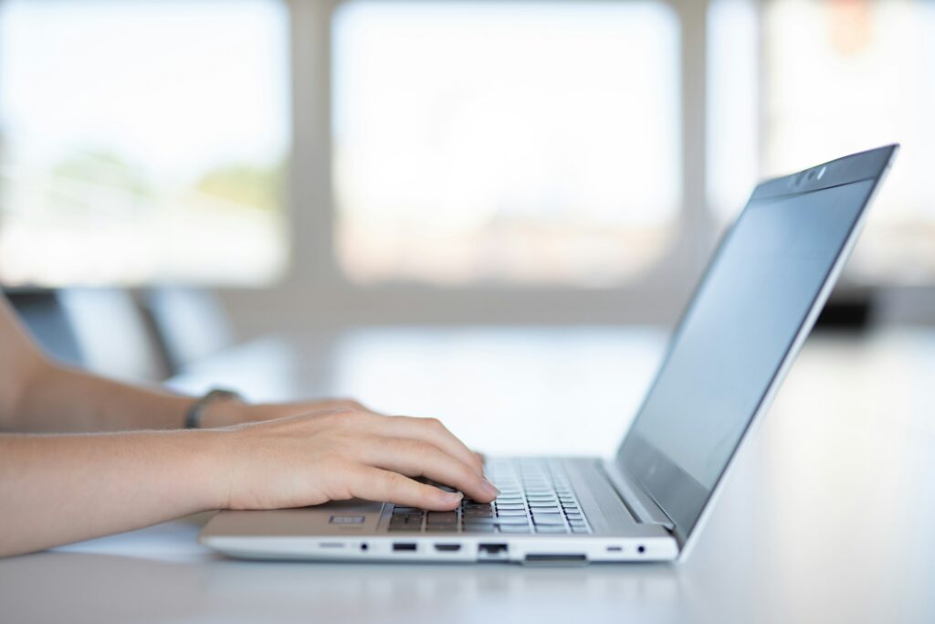 Technician working on a laptop remotely